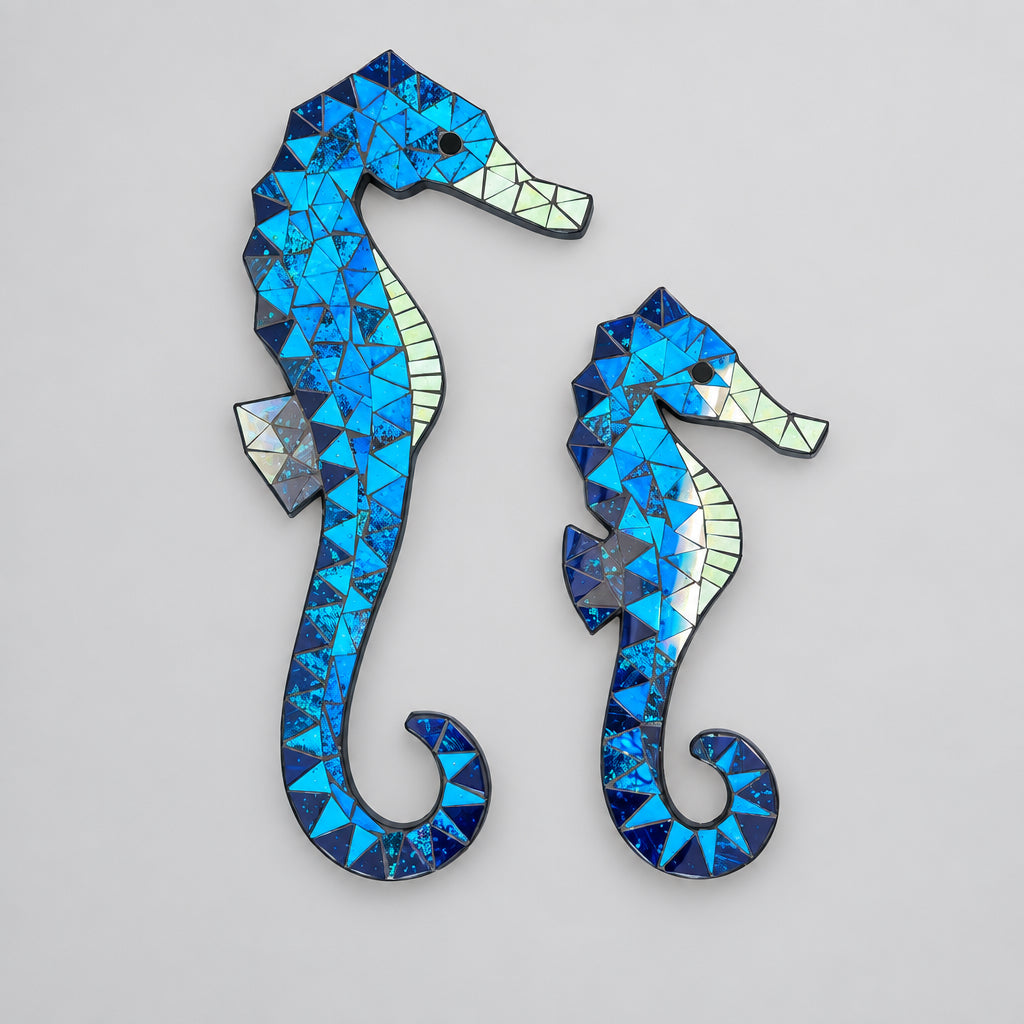 Two seahorse-shaped wall art pieces made of blue mosaic tiles with iridescent accents, displayed against a light gray background. Seahorse Wall Art, Affirmations & Hangings at World Of Decor NZ